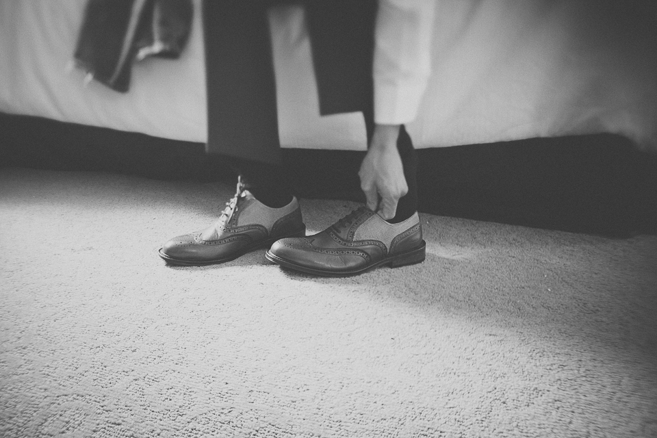 06 groom putting on shoes - Wedding Photographer in Chicago // Jessica + Aaron