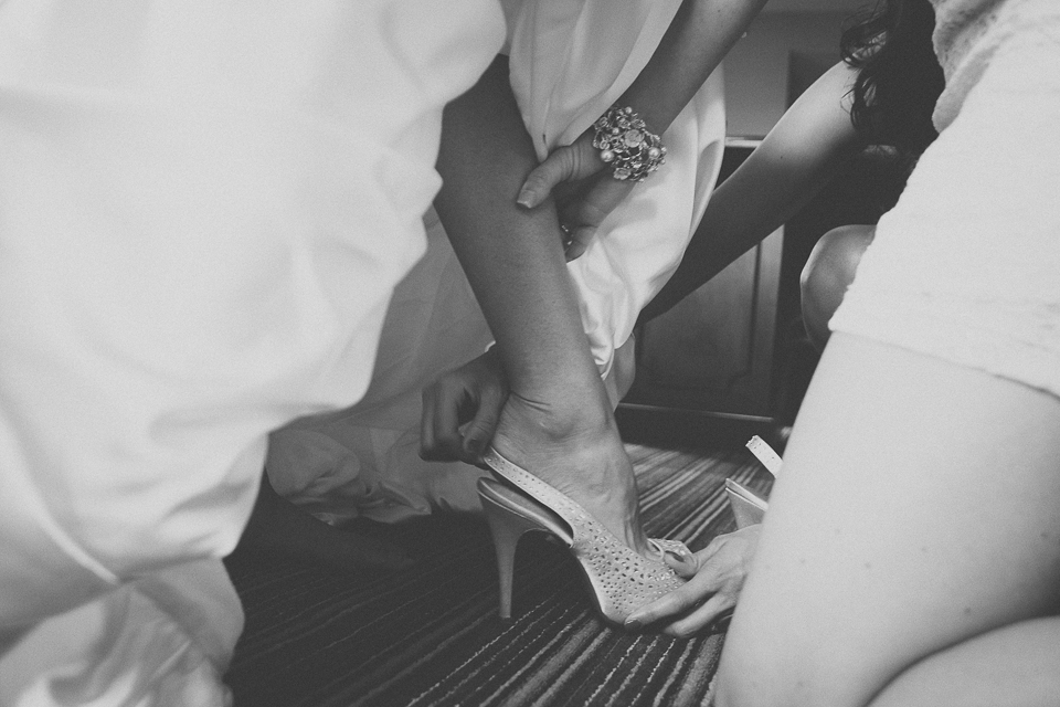18 black and white photo of bride putting on shoes - Wedding Photographer in Chicago // Jessica + Aaron