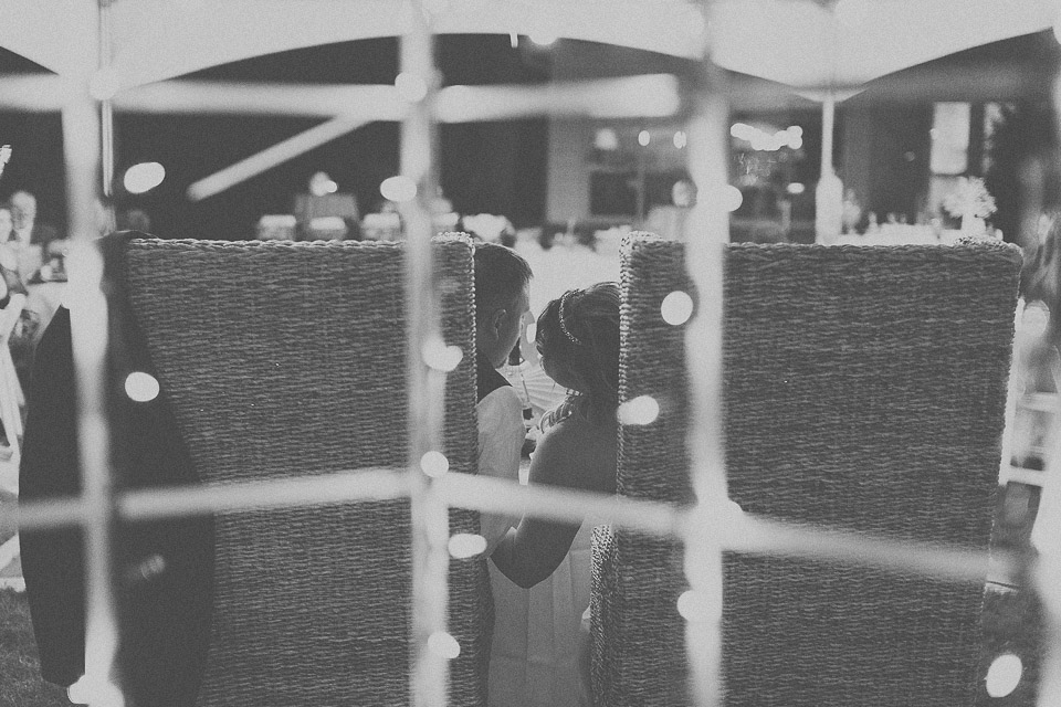 42 bride and groom sneak a kiss - AnaLorena + Bill // Wedding Photographer in Chicago