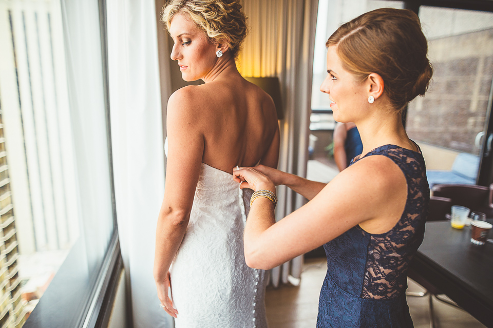 17 bride putting dress on - Jay + Callie // Downtown Chicago Wedding Photographer