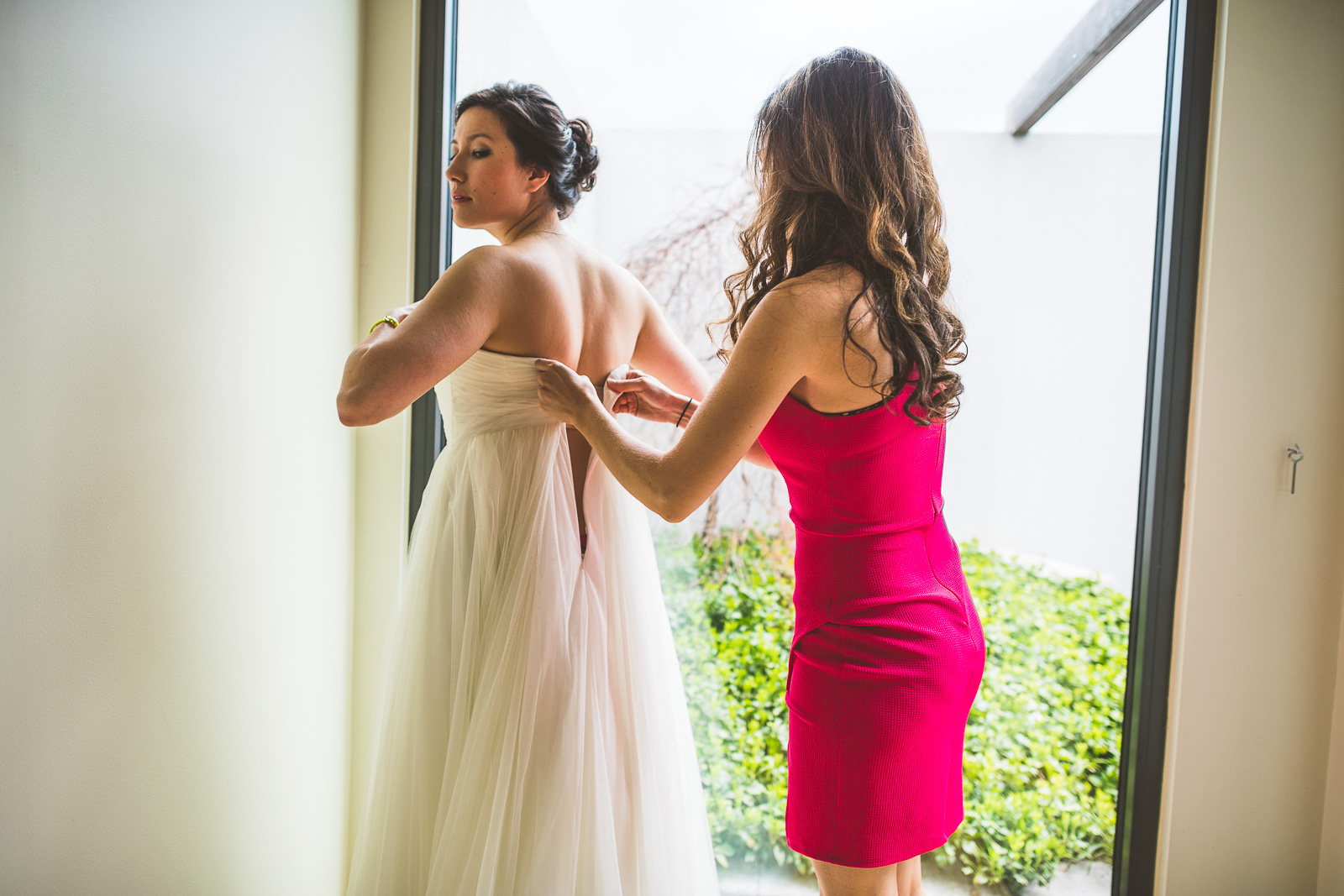 06 bride getting into dress - Jackie + Raj // Chicago Wedding Photography at Floating World Gallery