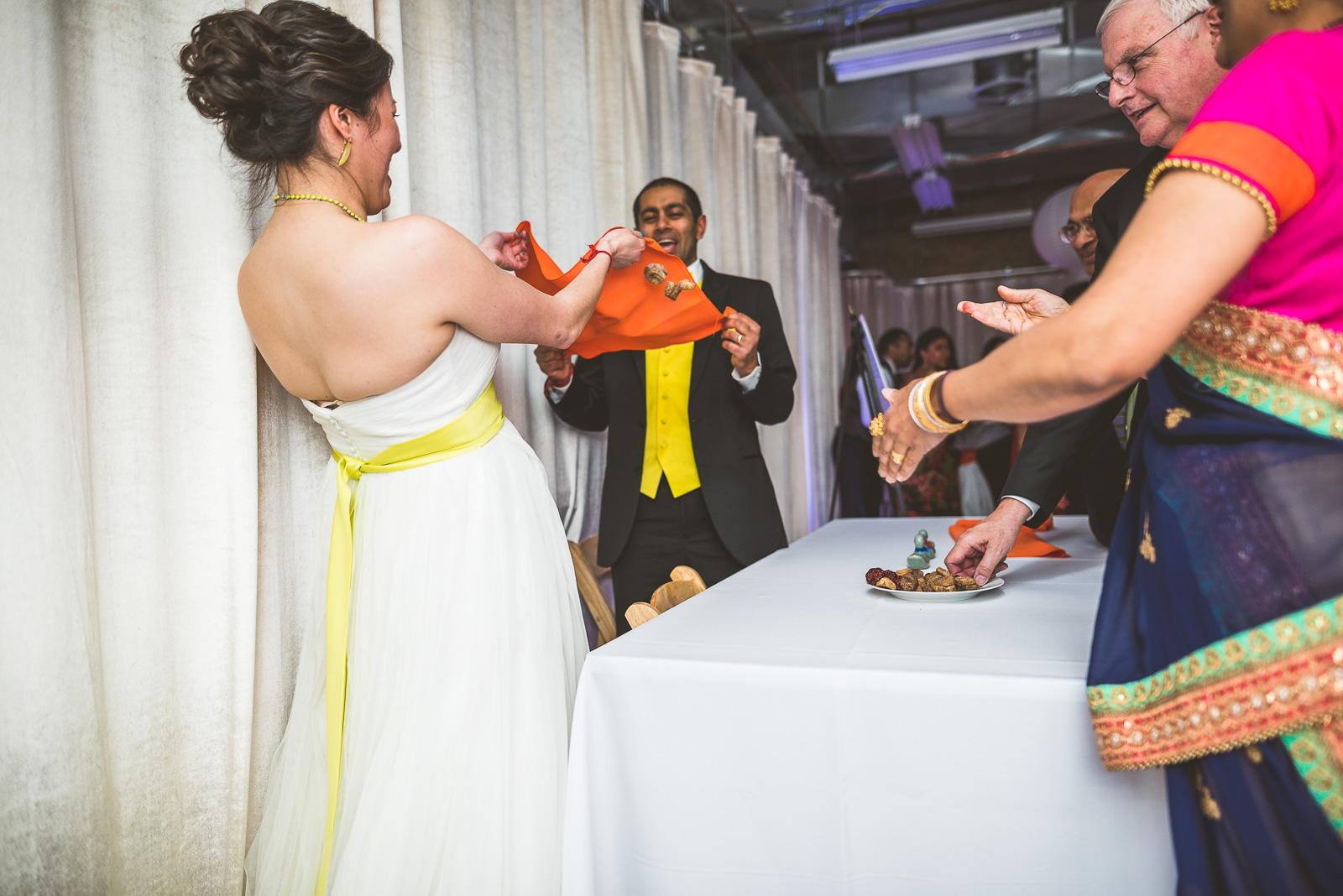 55 bride and groom catching nuts - Jackie + Raj // Chicago Wedding Photography at Floating World Gallery