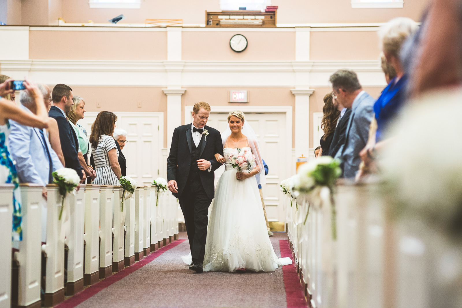 34 bride coming down isle in church - Kristina + Dave // Wedding Photographer in Chicago
