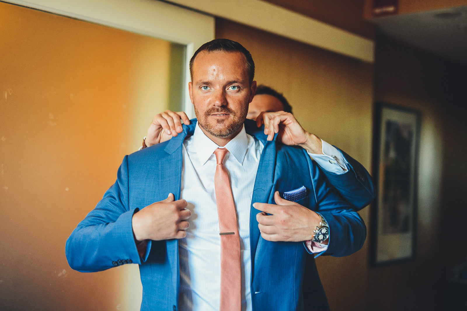 12 groom putting on suit in chicago - Natalie + Alan // Chicago Wedding Photographer at Cafe Brauer