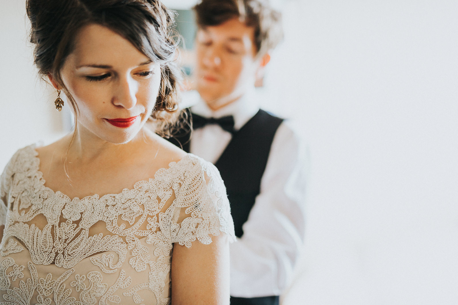 15 groom dressing bride before wedding - Megan + Jon // Orpheum Wedding Photography in Madison