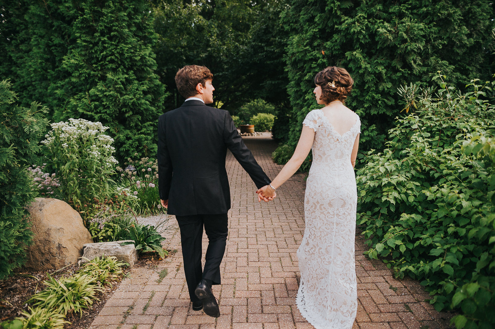 35 bride and groom walking together through park - Megan + Jon // Orpheum Wedding Photography in Madison