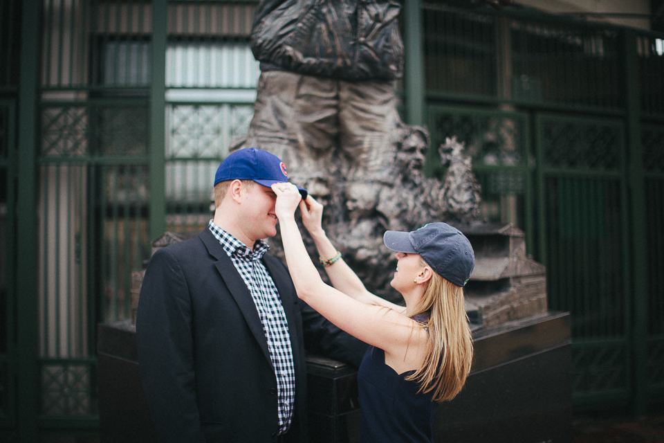 putting on cubs hats during engagement session