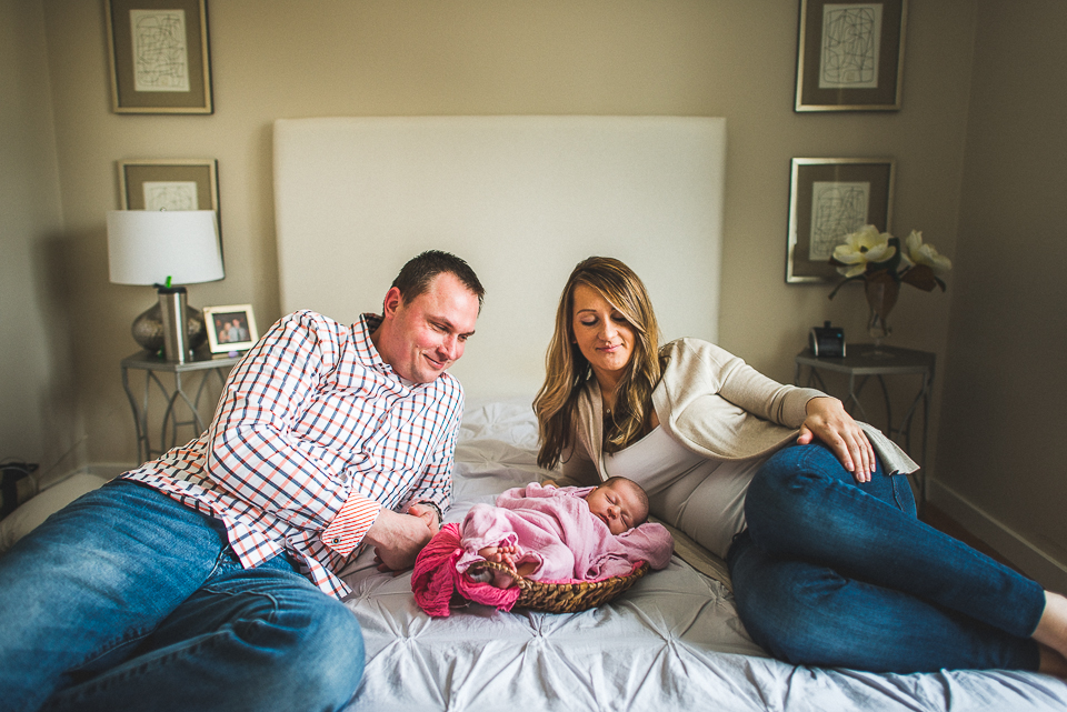 09 parents with newborn on bed during oakbrook photo session