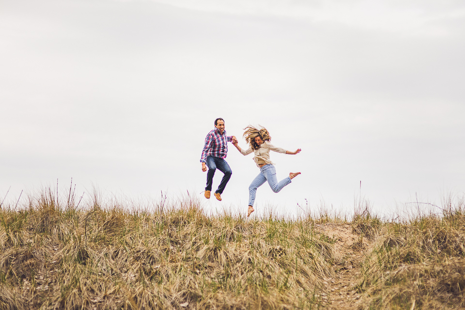 12 fun couple jumping on engagement shoot