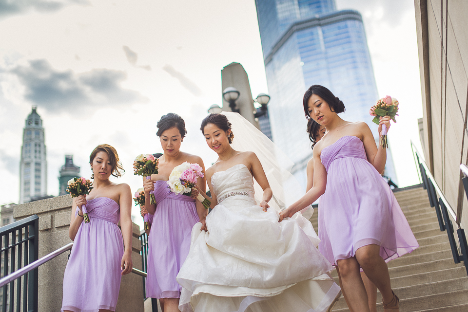 26 bride with bridesmaids walking towards the river in chicago