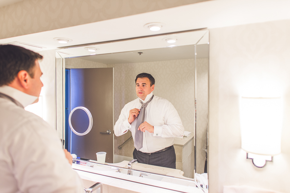 08 groom getting ready in mirror