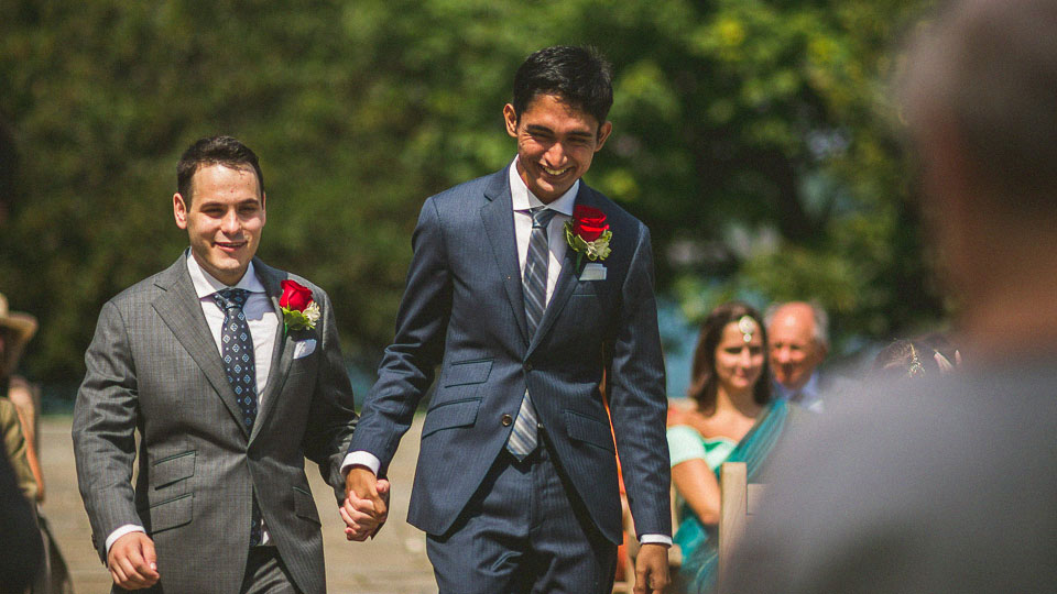 11 grooms happy walking down the isle at same sex wedding