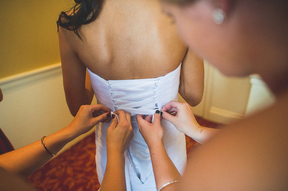 18 bride putting on dress