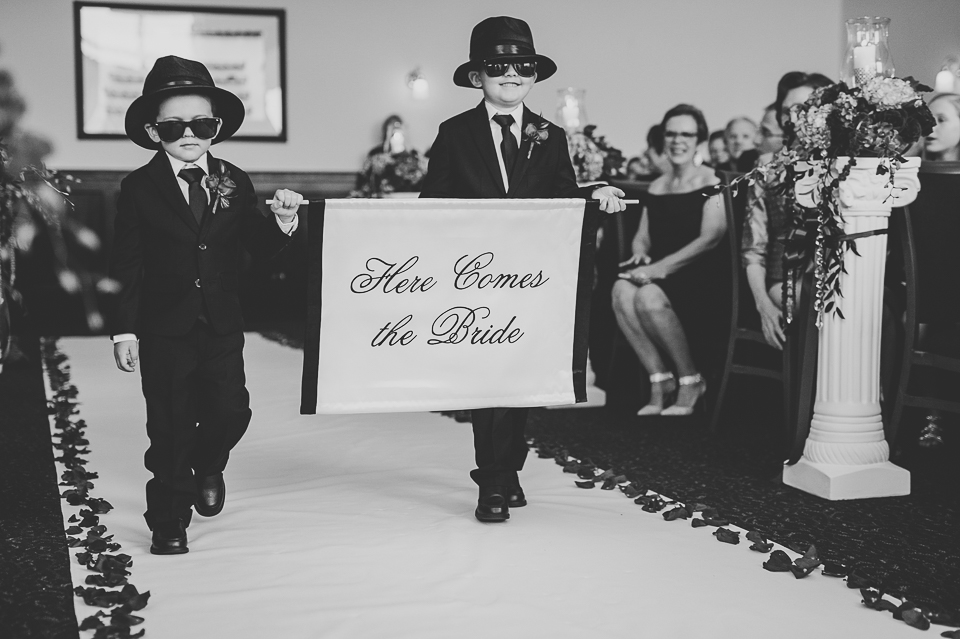 32 walking down the isle with sign