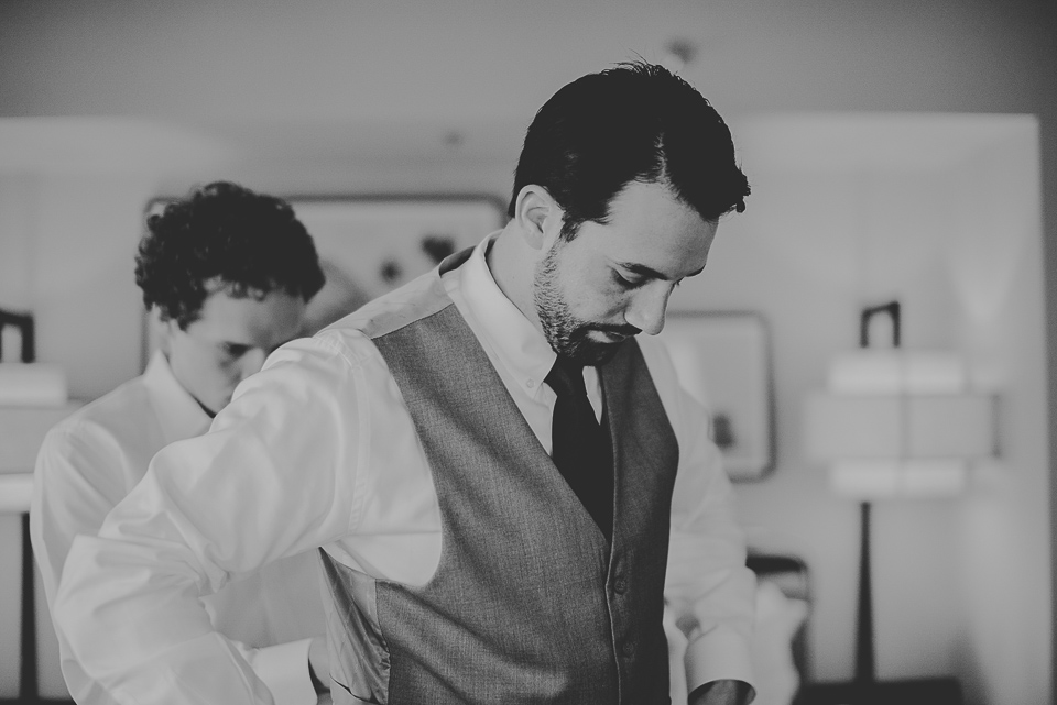 10 black and white groom getting ready