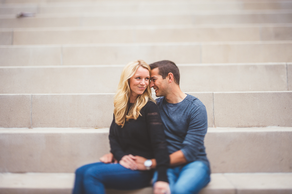 17 couple sitting at chicago riverwalk during engagement session