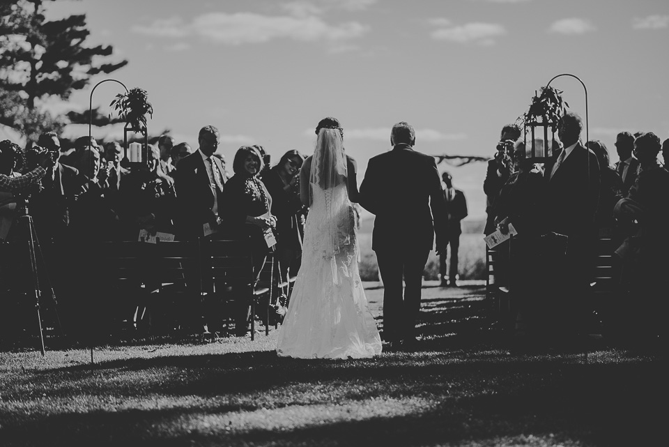 48 black and white of bride coming down the isle