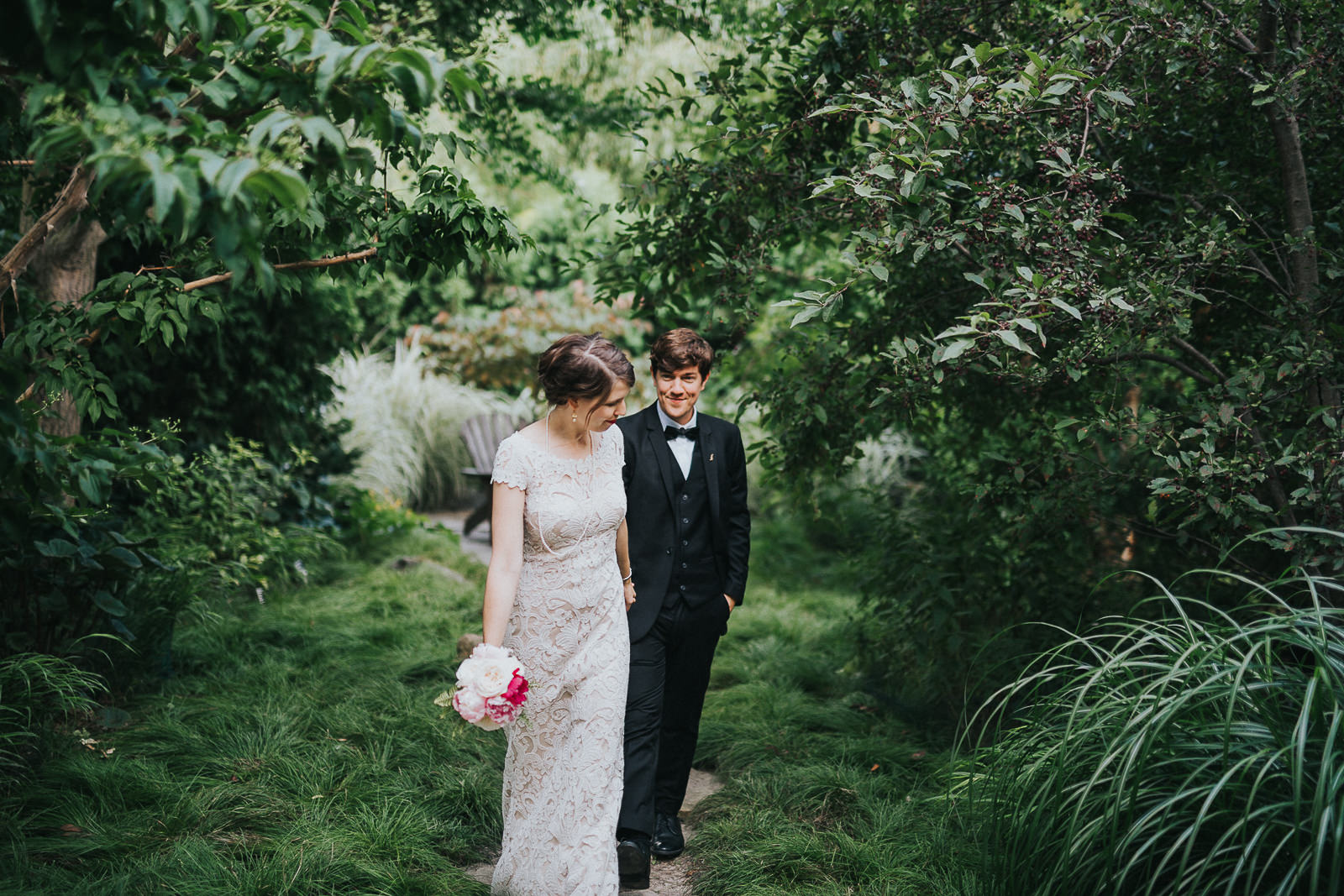 40 bride and groom walking through garden